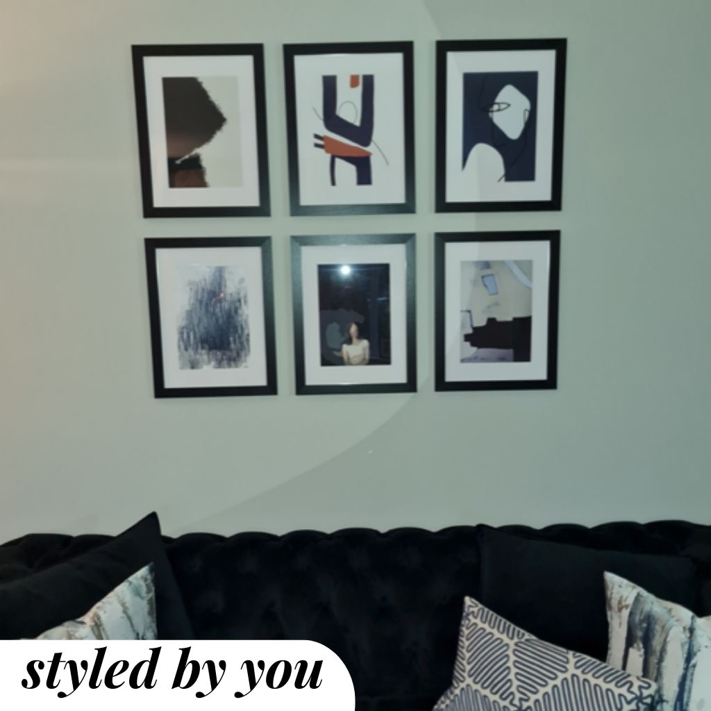 framed prints hung on a wall
