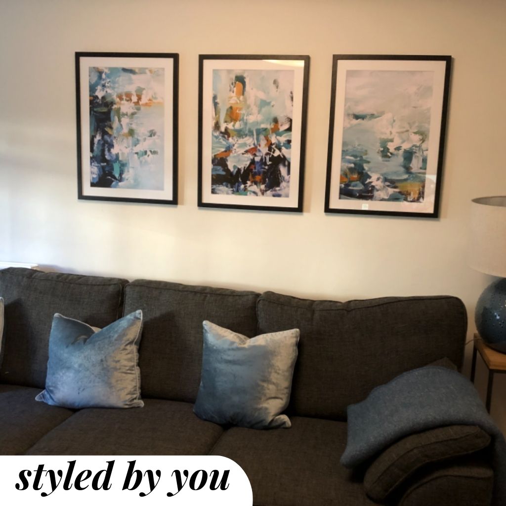 framed prints hung above a sofa