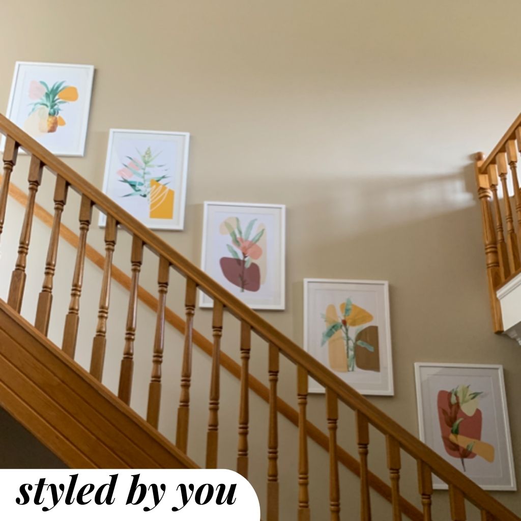 framed prints above a staircase
