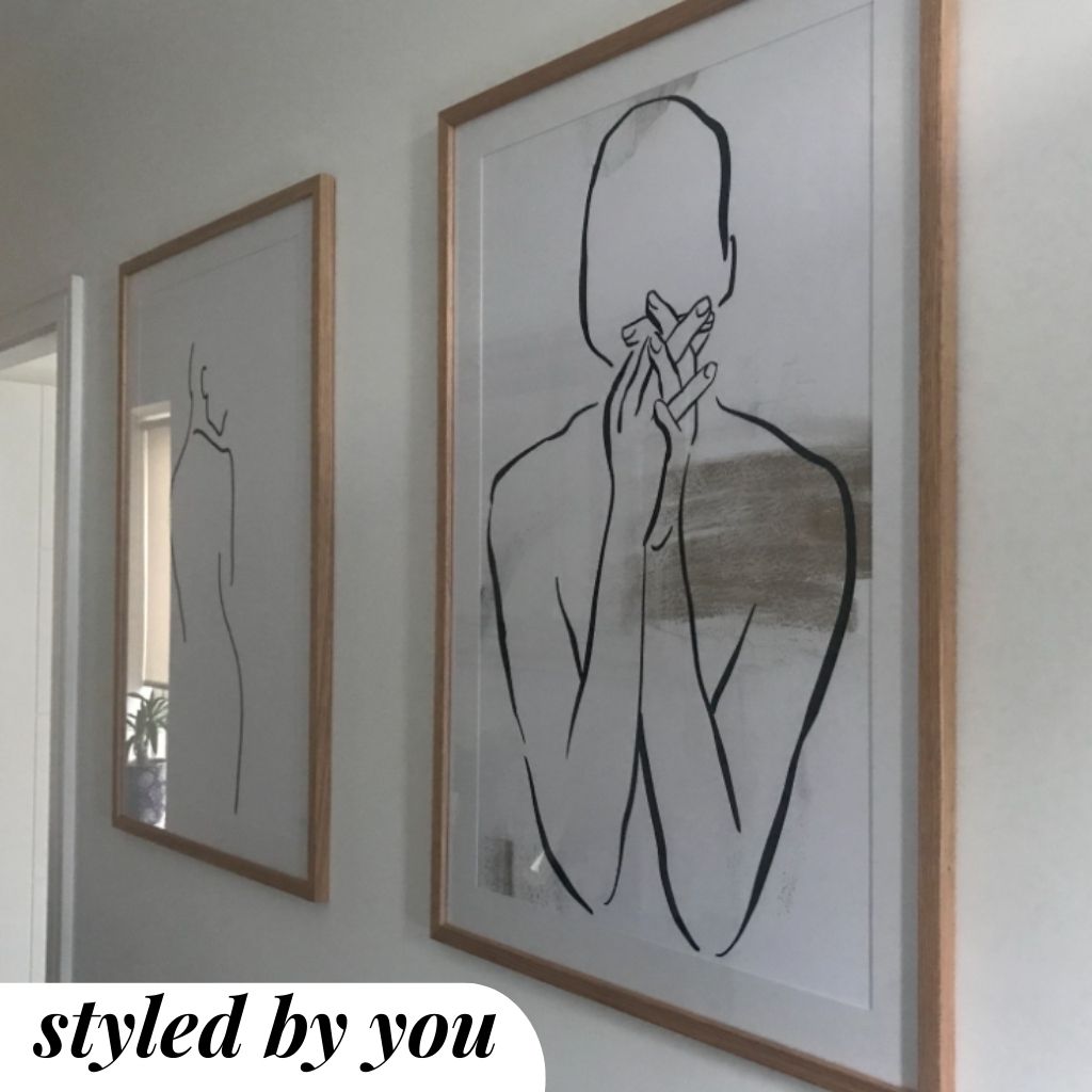 framed prints hung on a wall 