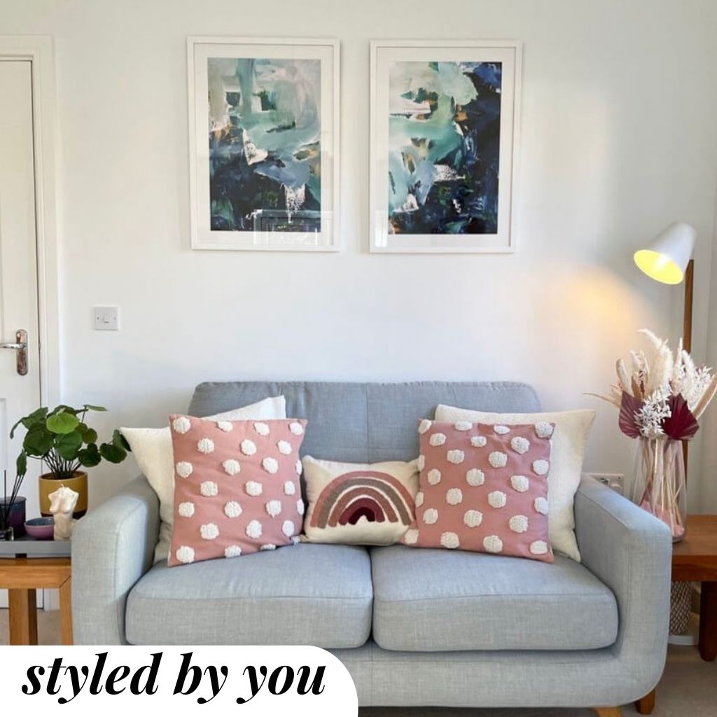 framed prints above a sofa
