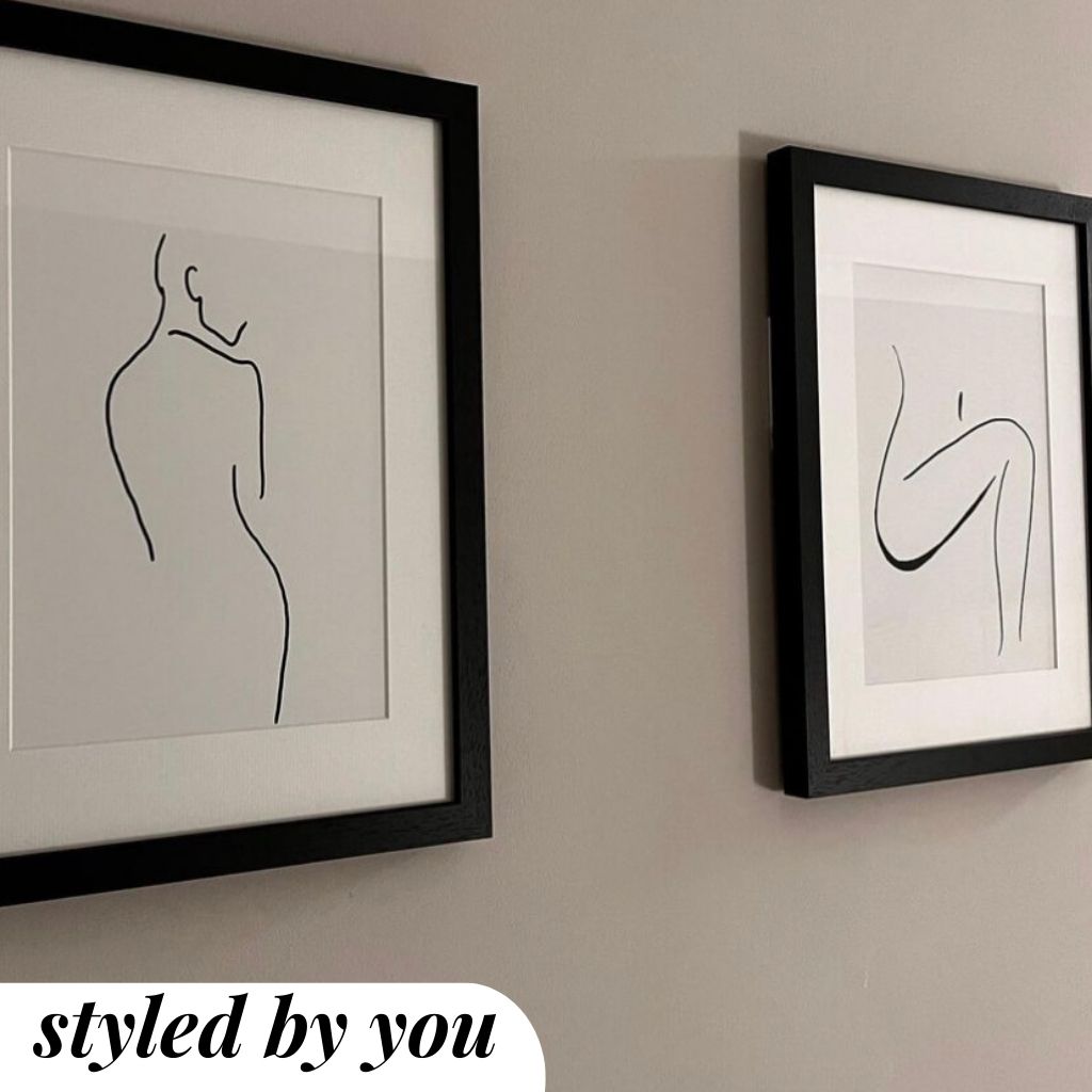 framed prints hung on a wall 