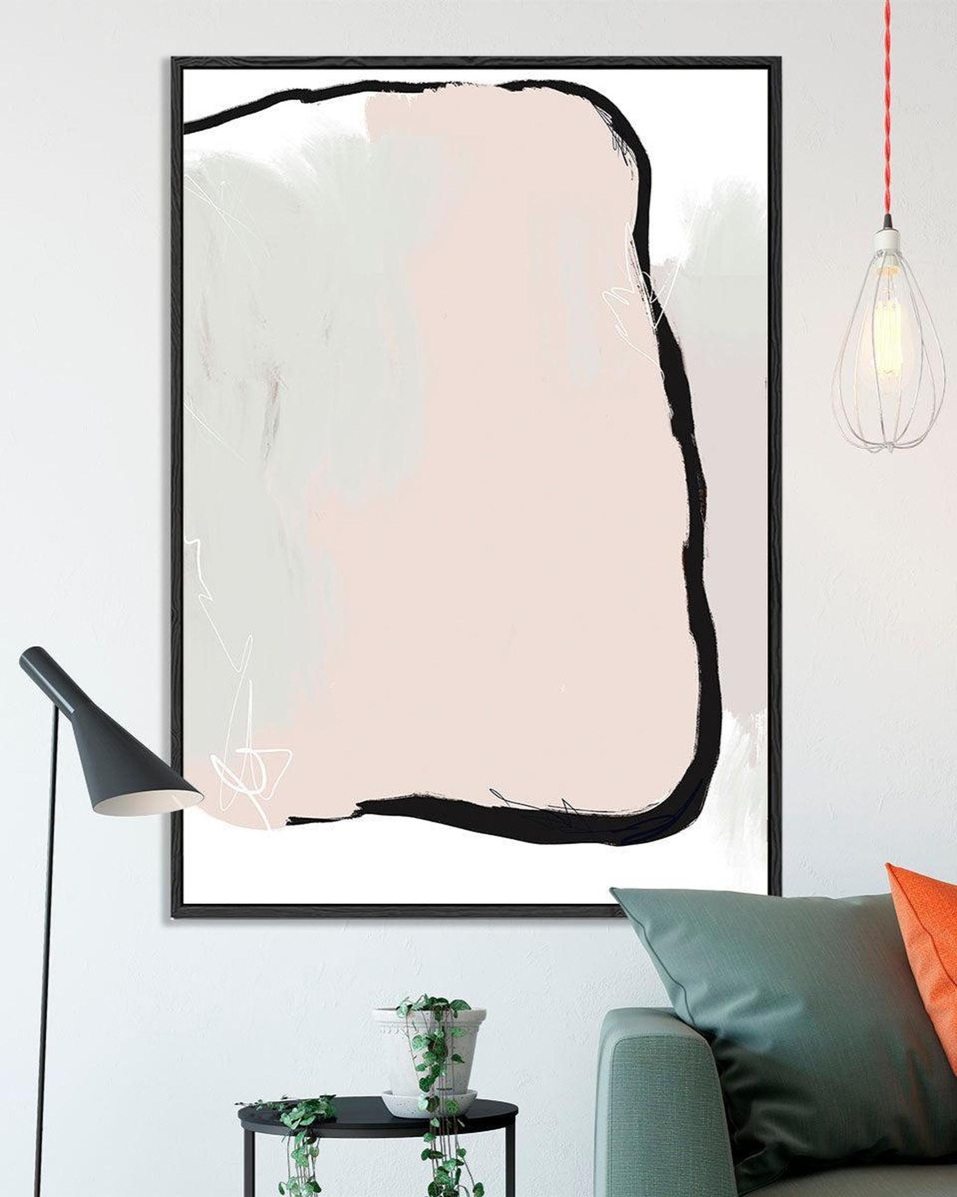 Modern living room with a framed abstract art piece, lamp, and sofa.