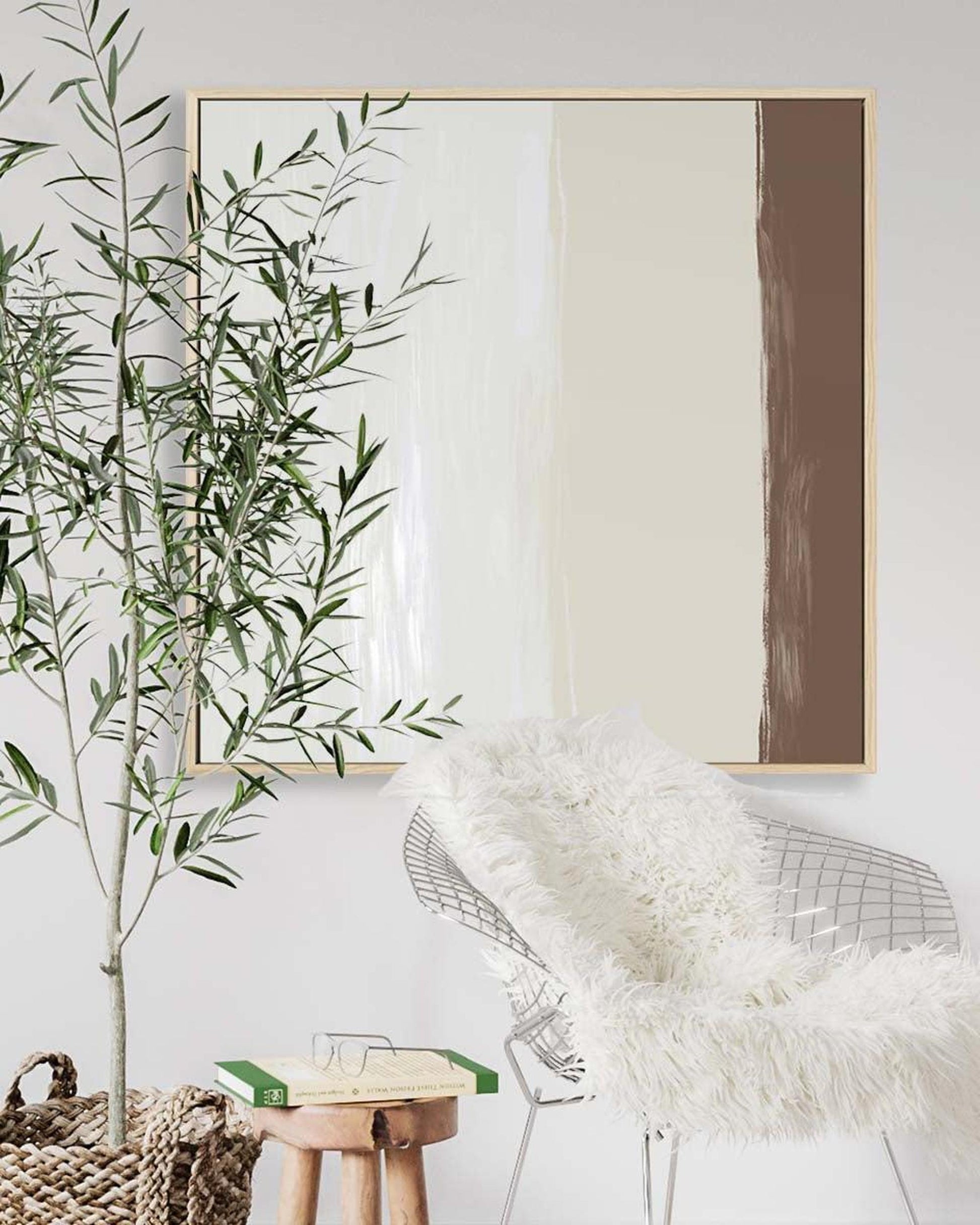 Modern interior with abstract art, plant, and chair with fur cover.