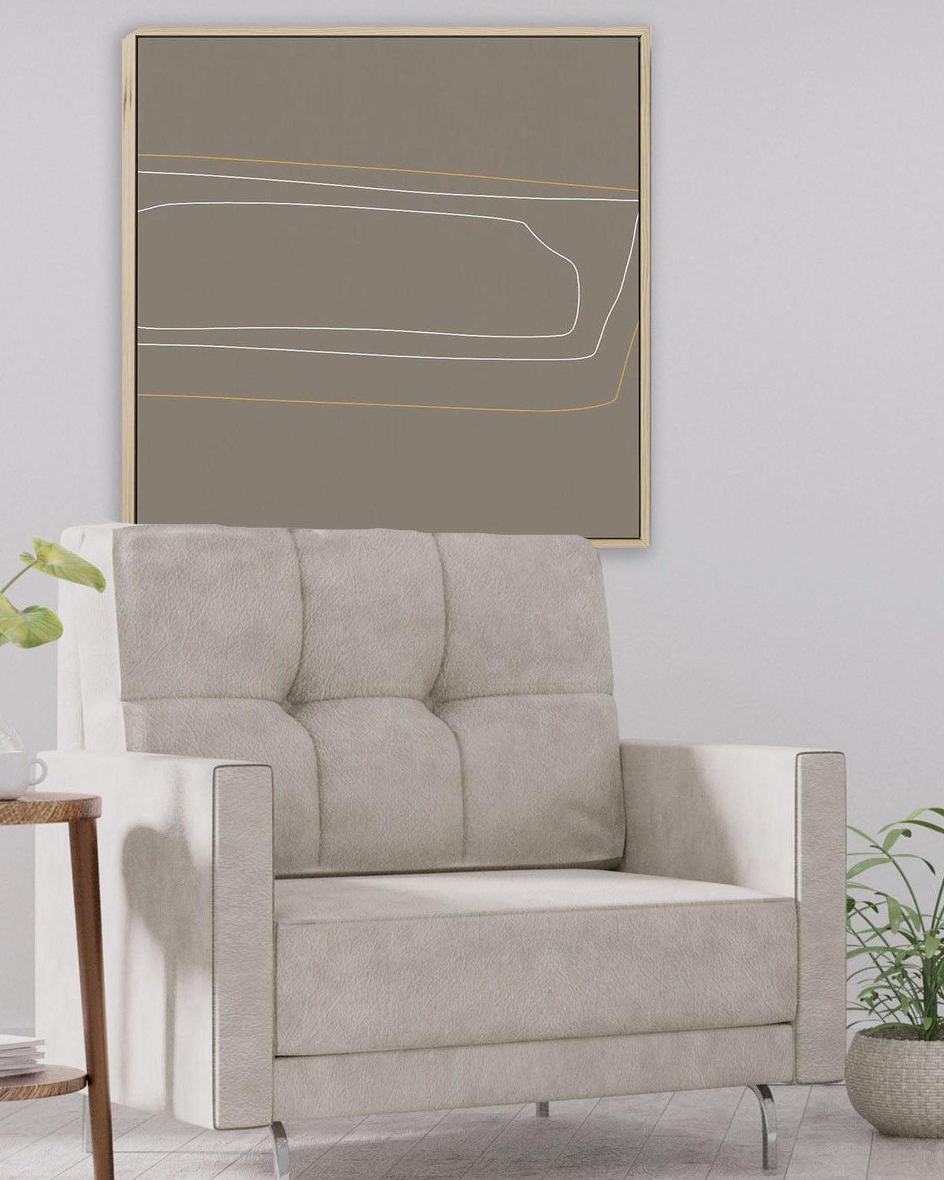 Gray sofa in a room with a large abstract painting on the wall.
