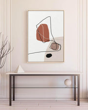 Abstract art print on a wall above a glass table
