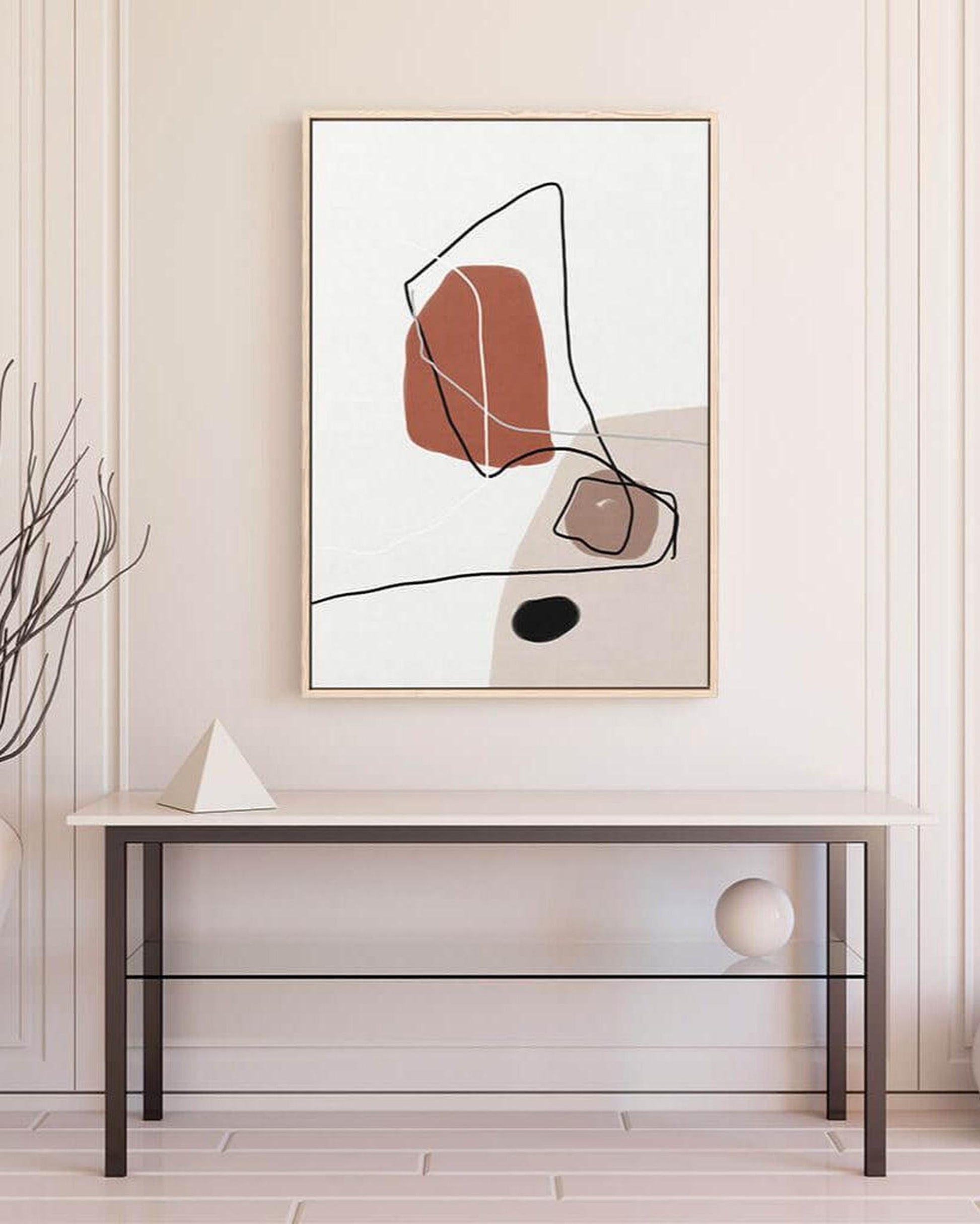 Abstract art print on a wall above a glass table