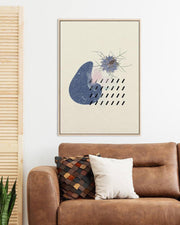Framed abstract art above a brown sofa with decorative pillows