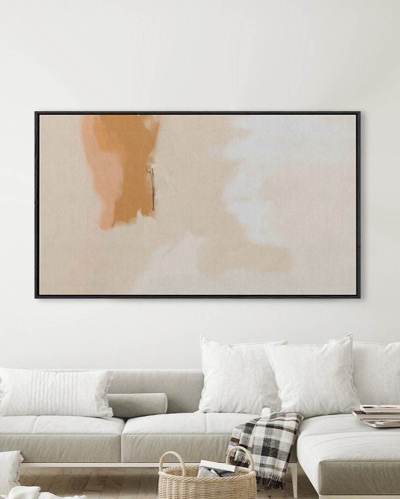 Abstract art piece on a wall above a sofa in a living room
