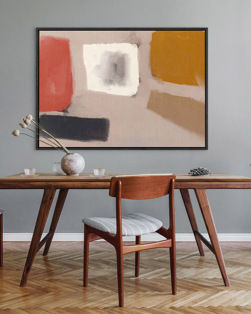Dining room with a wooden table and chair, abstract art on the wall.