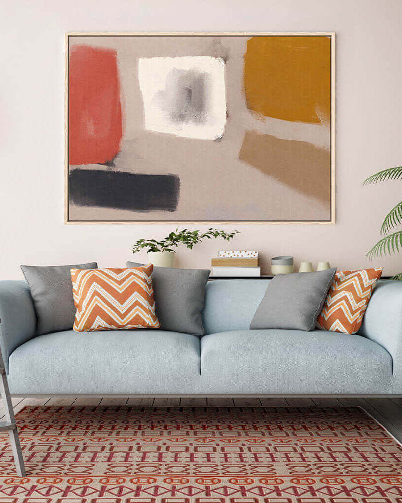 Living room with a light blue sofa, colorful cushions, and abstract art on the wall.