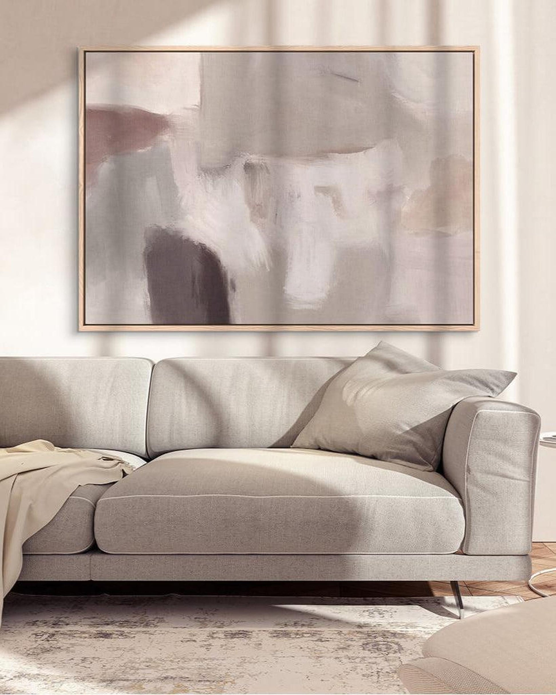 Gray sofa with abstract art in a living room setting