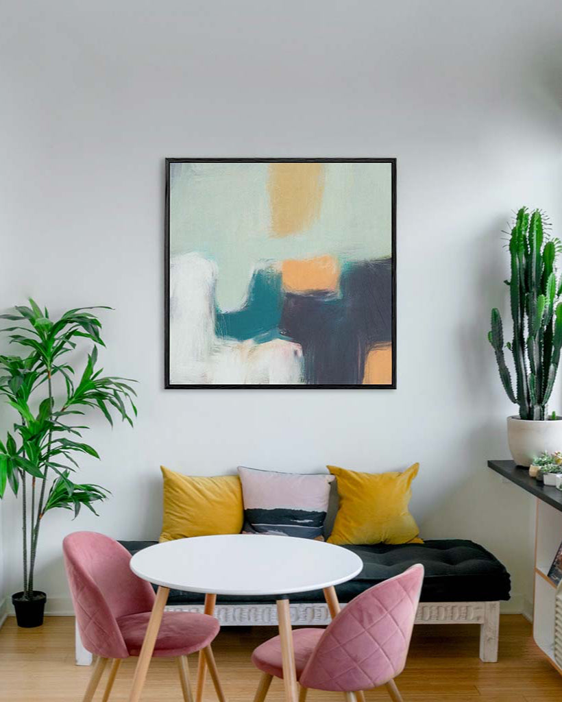 Modern living room with abstract art, colorful cushions, and plants.