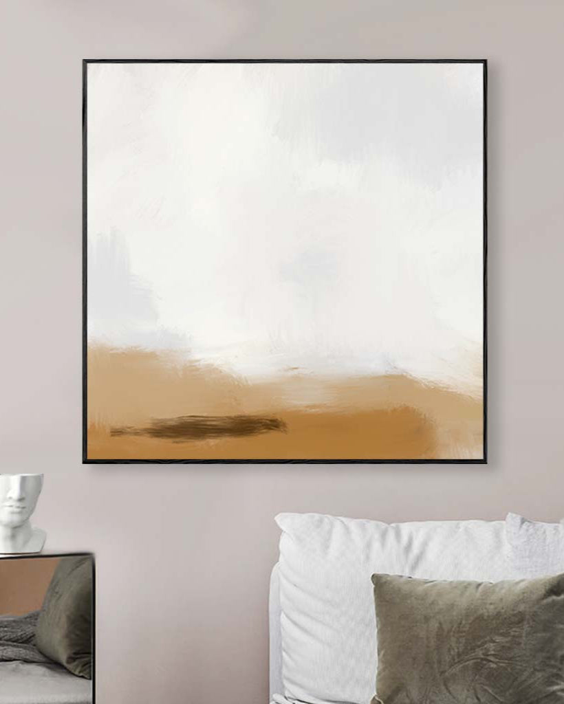Abstract art piece with a gradient from white to brown in a black frame, hanging on a wall above a sofa.
