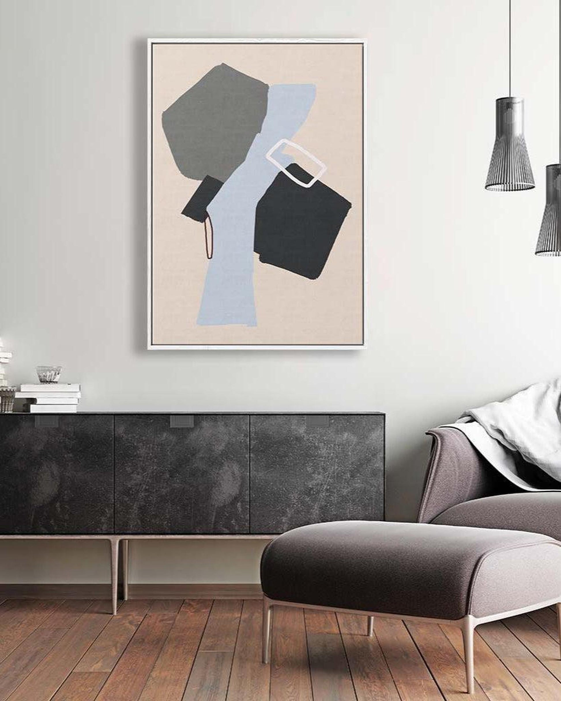 Modern living room with abstract art on the wall, gray sofa, and wooden floor.