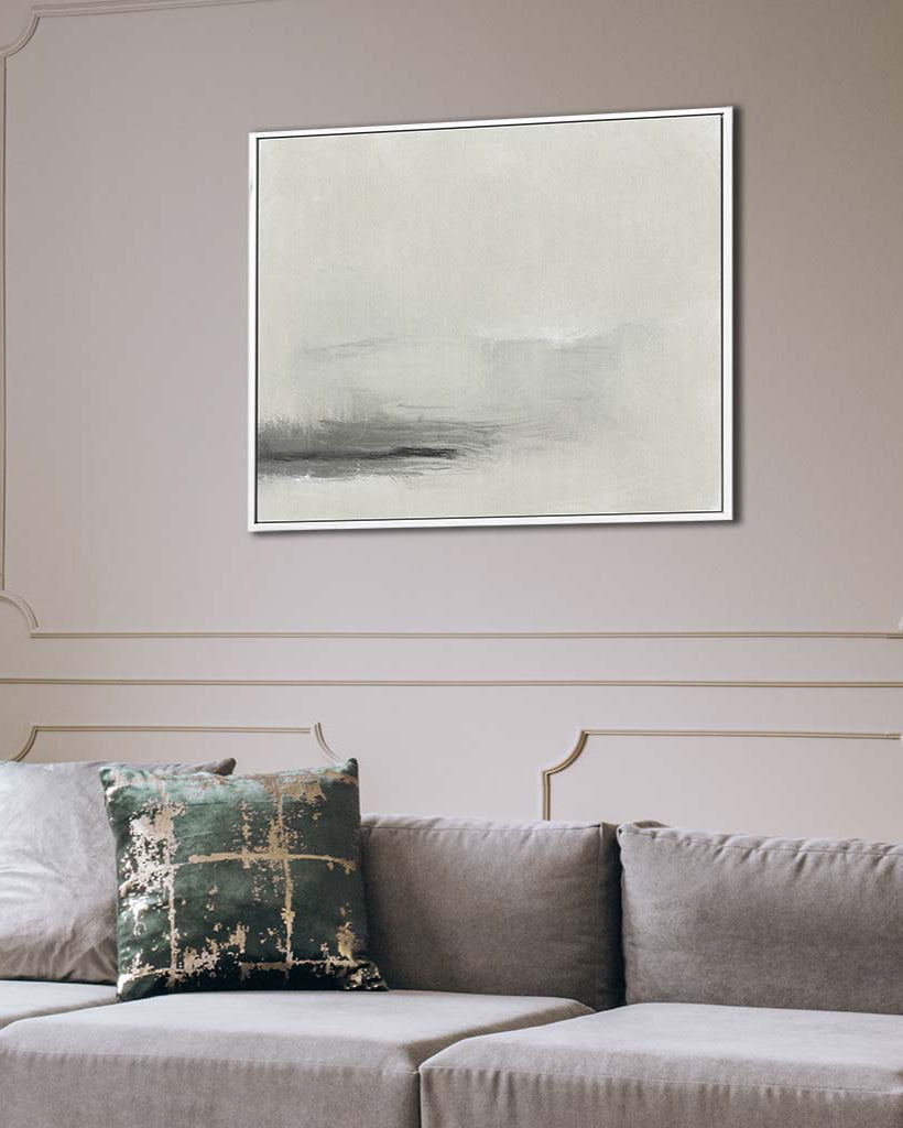 Abstract painting on a wall above a gray sofa with a decorative pillow.