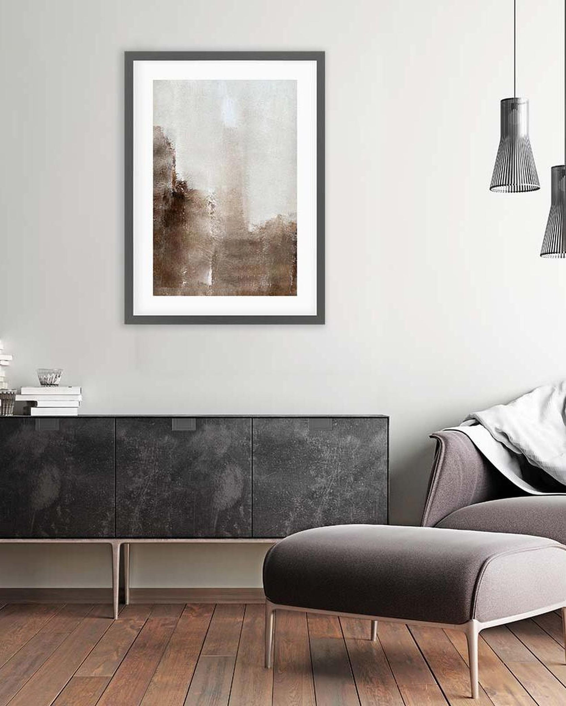 Modern living room with a framed abstract painting on the wall, a gray sofa, and a wooden floor.