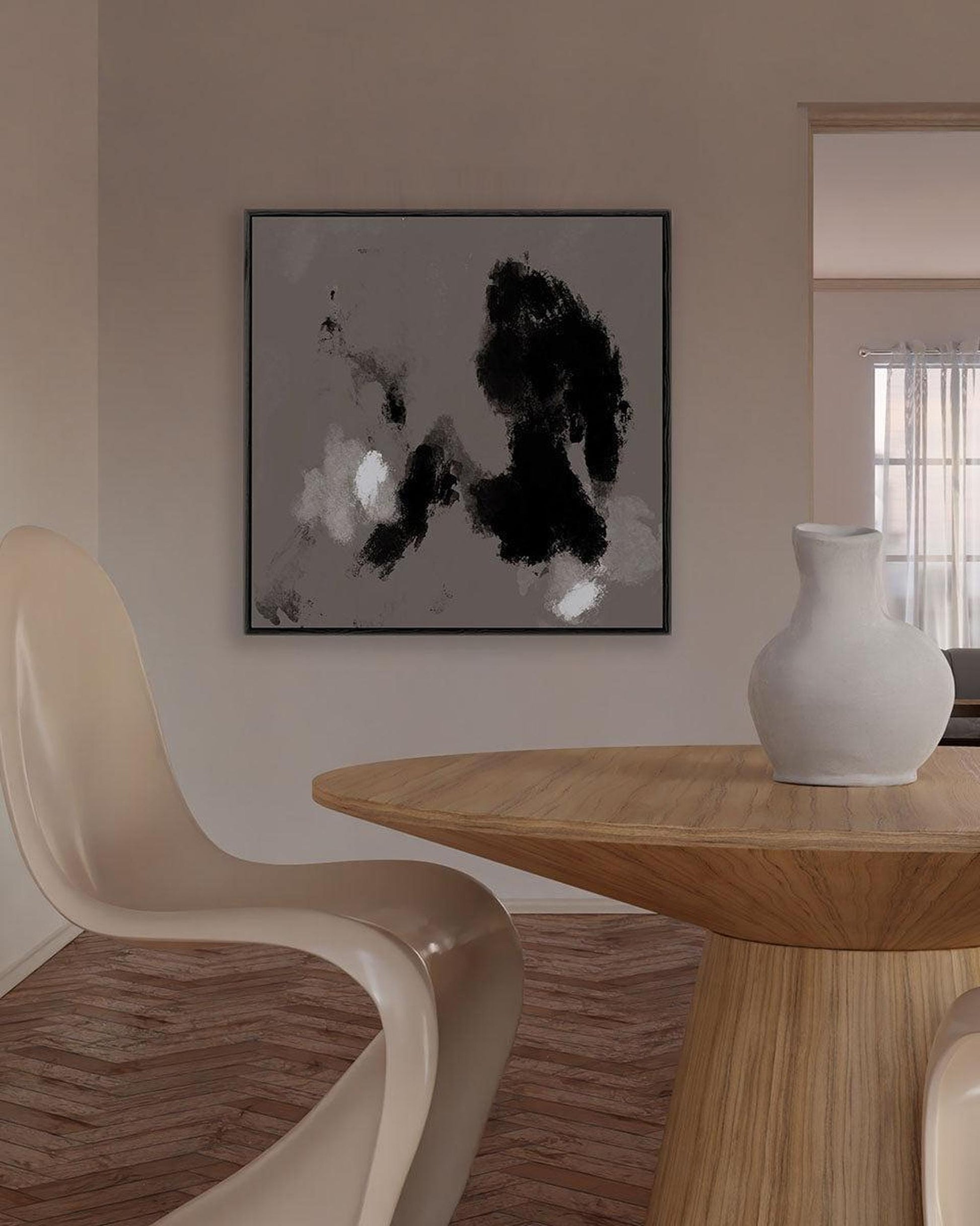 Dining room with a wooden table, beige chair, and abstract art on the wall.