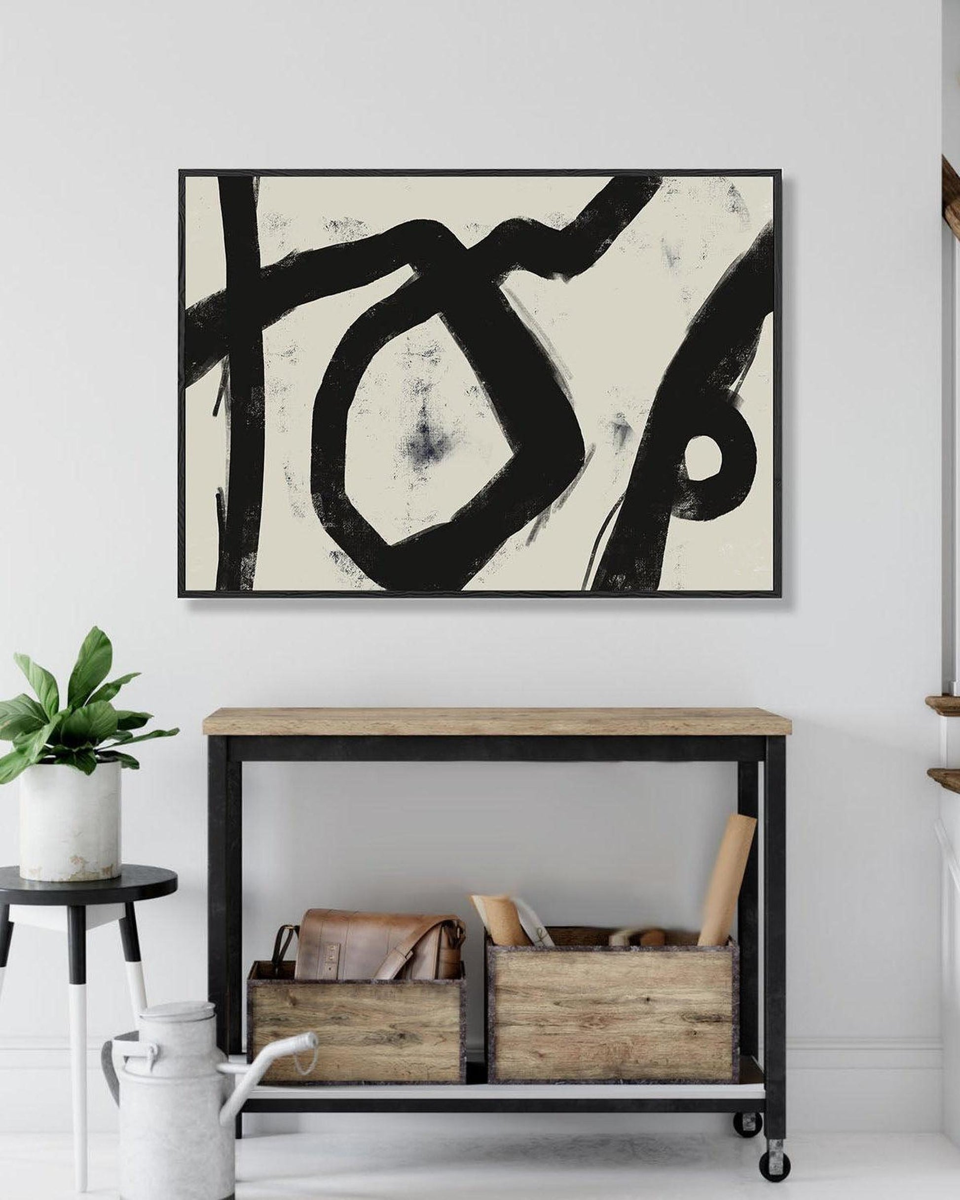 Modern interior with abstract art, console table, and plants.