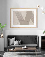 Modern living room with a black sofa, wooden coffee table, and abstract art on the wall.