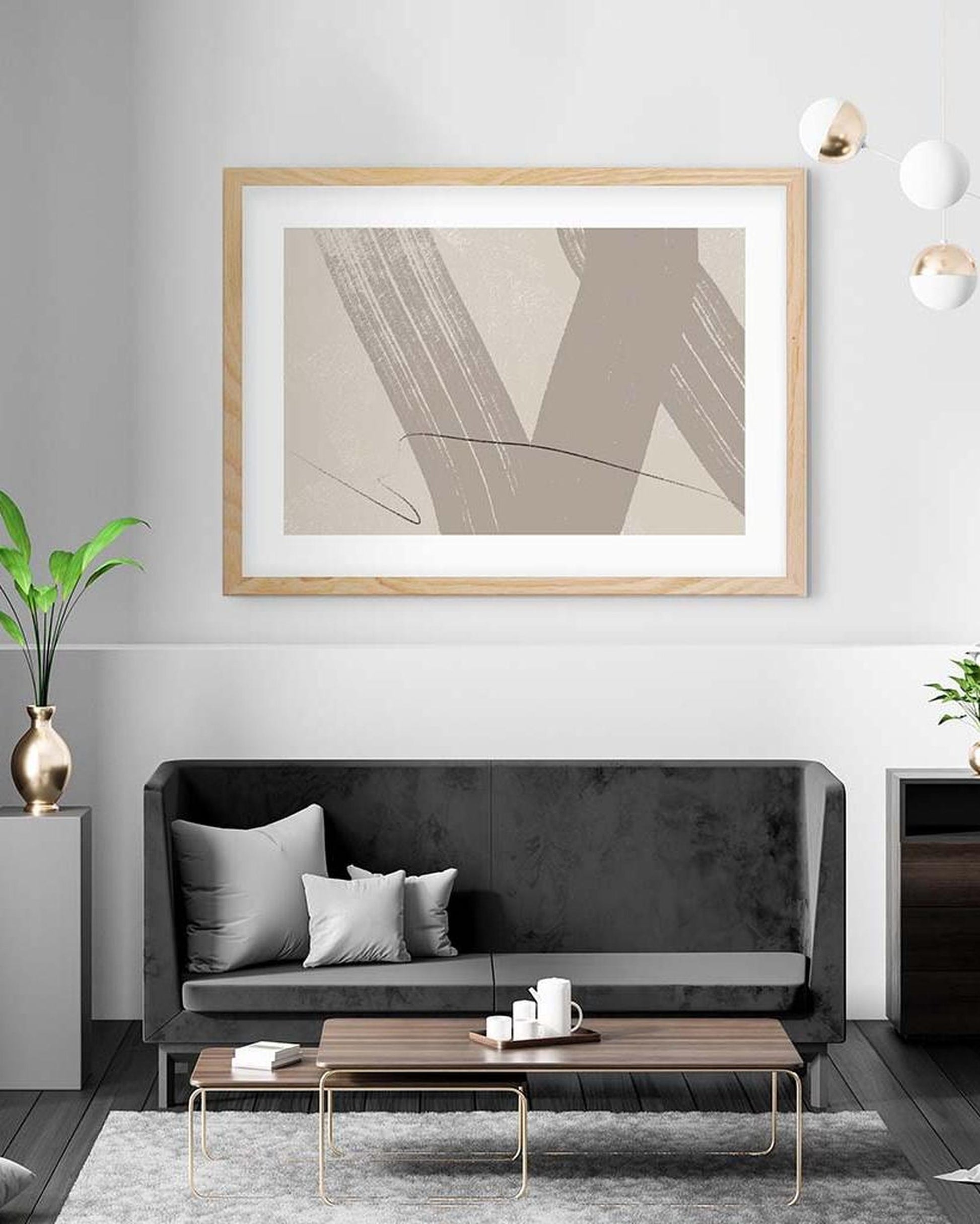 Modern living room with a black sofa, wooden coffee table, and abstract art on the wall.