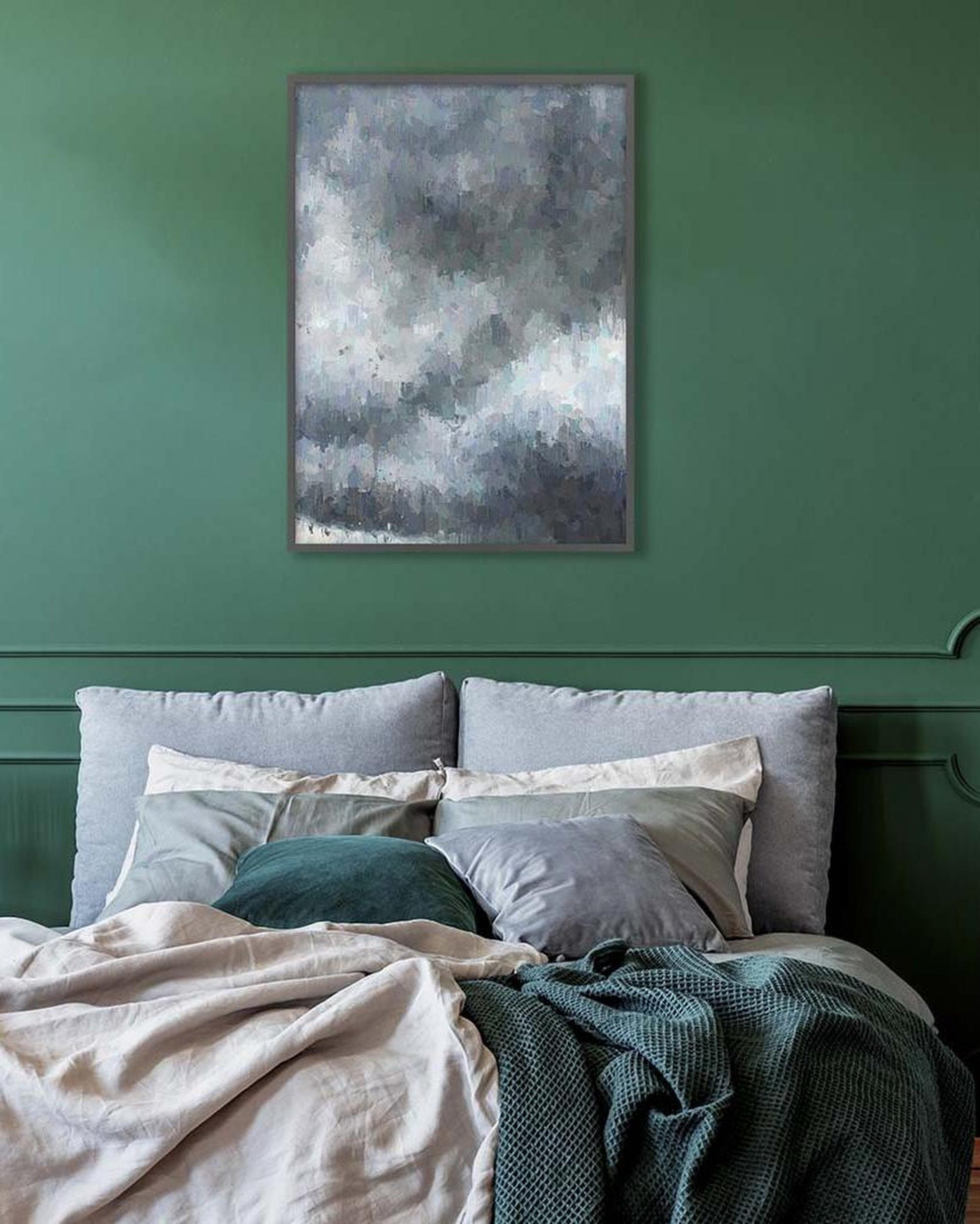 Bedroom with green walls, a bed with pillows and blankets, and an abstract painting above the bed.