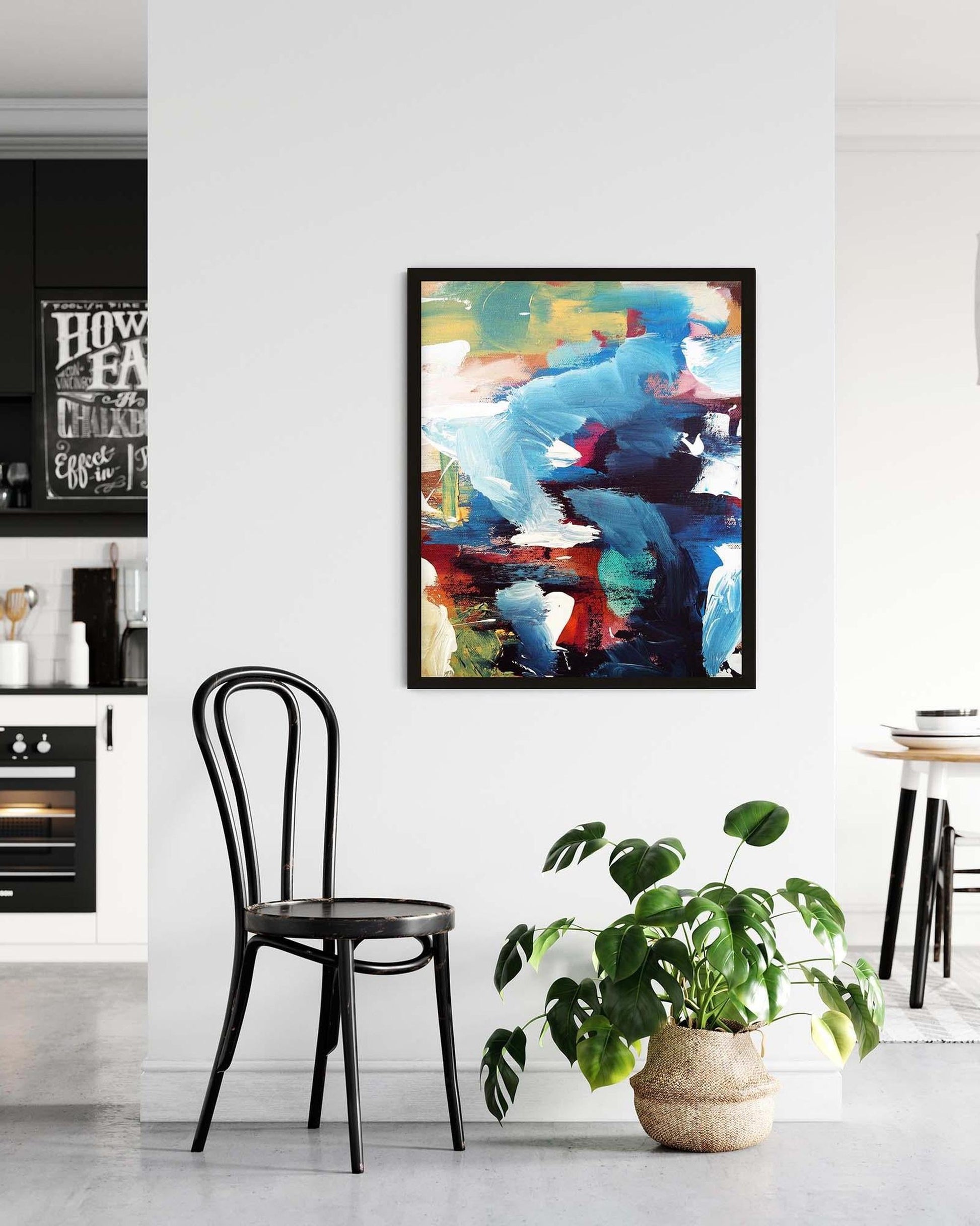 Abstract painting in a modern kitchen with a chair and plant