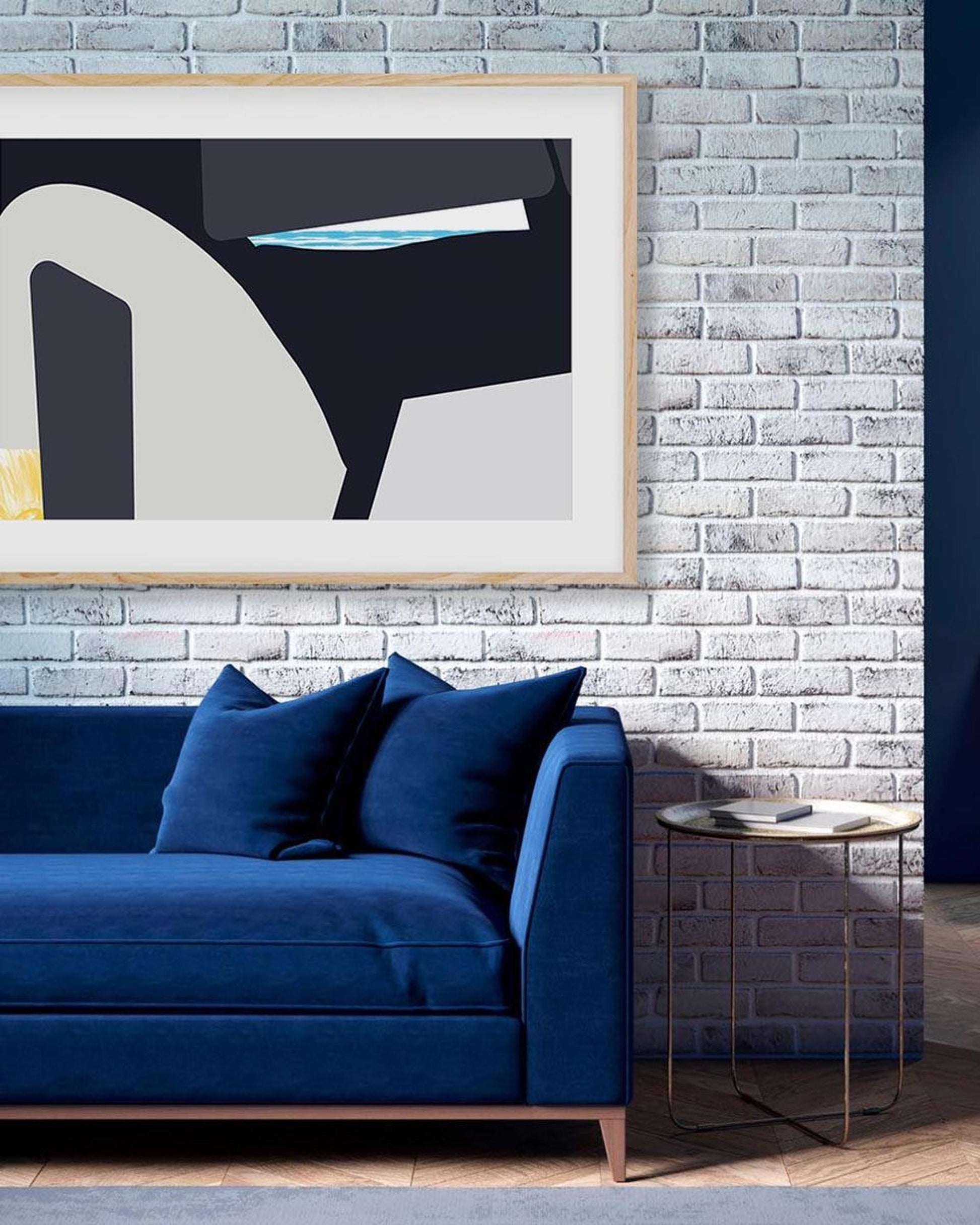Blue sofa against a textured wall with a framed abstract art piece.