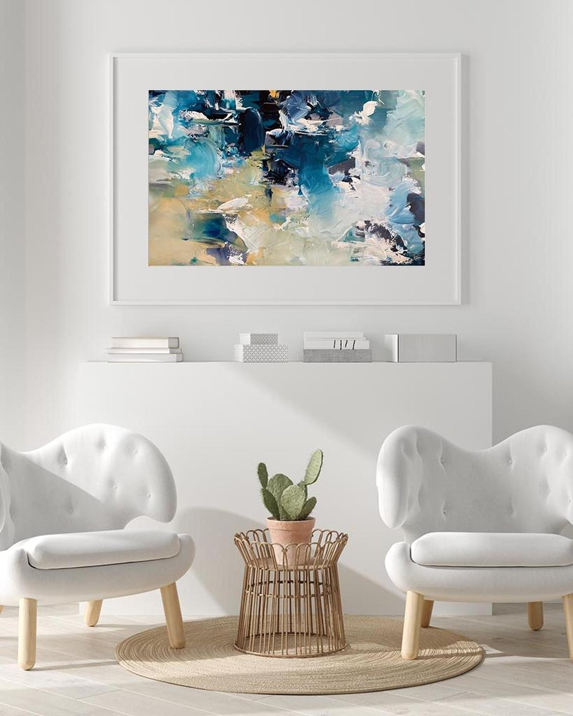 Modern living room with abstract art, white chairs, and a small table.