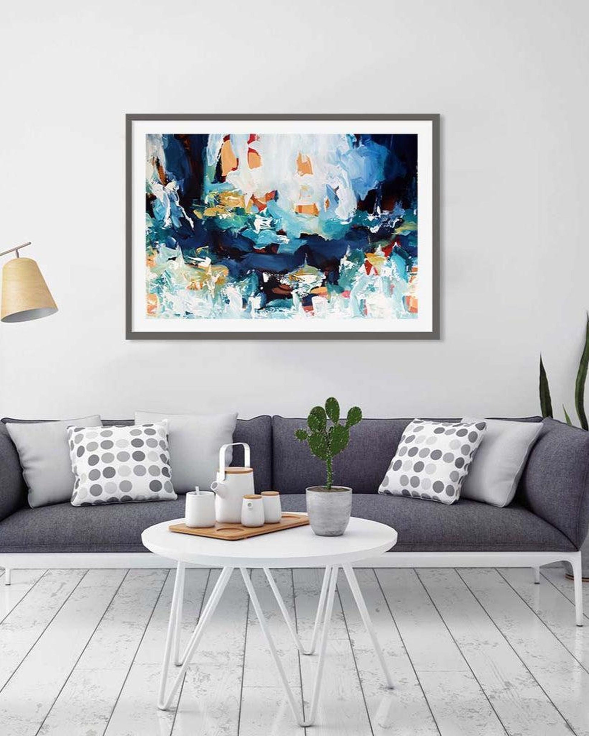 Framed abstract artwork above a sofa in a living room setting
