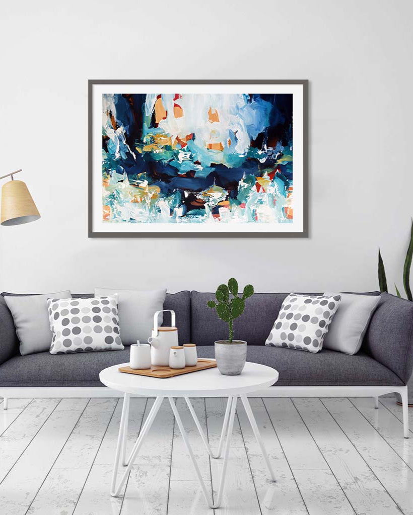 Framed abstract artwork above a sofa in a living room setting