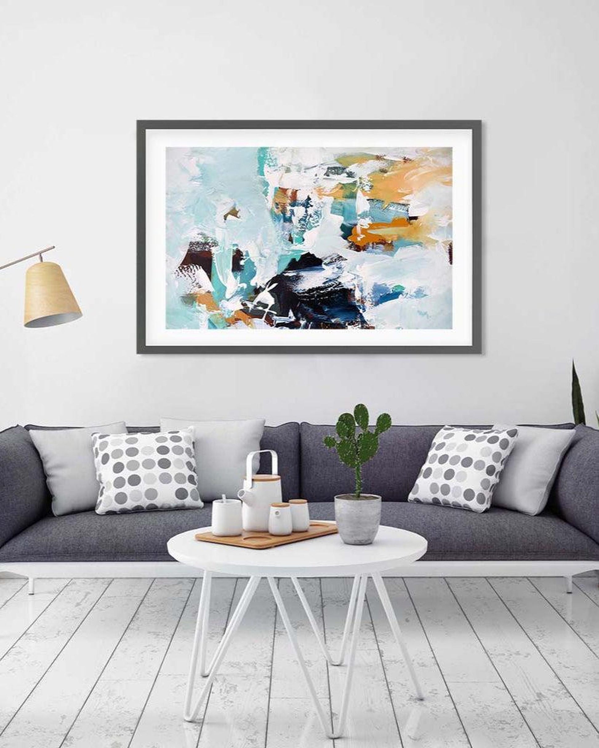 Abstract art print on a wall above a sofa in a living room