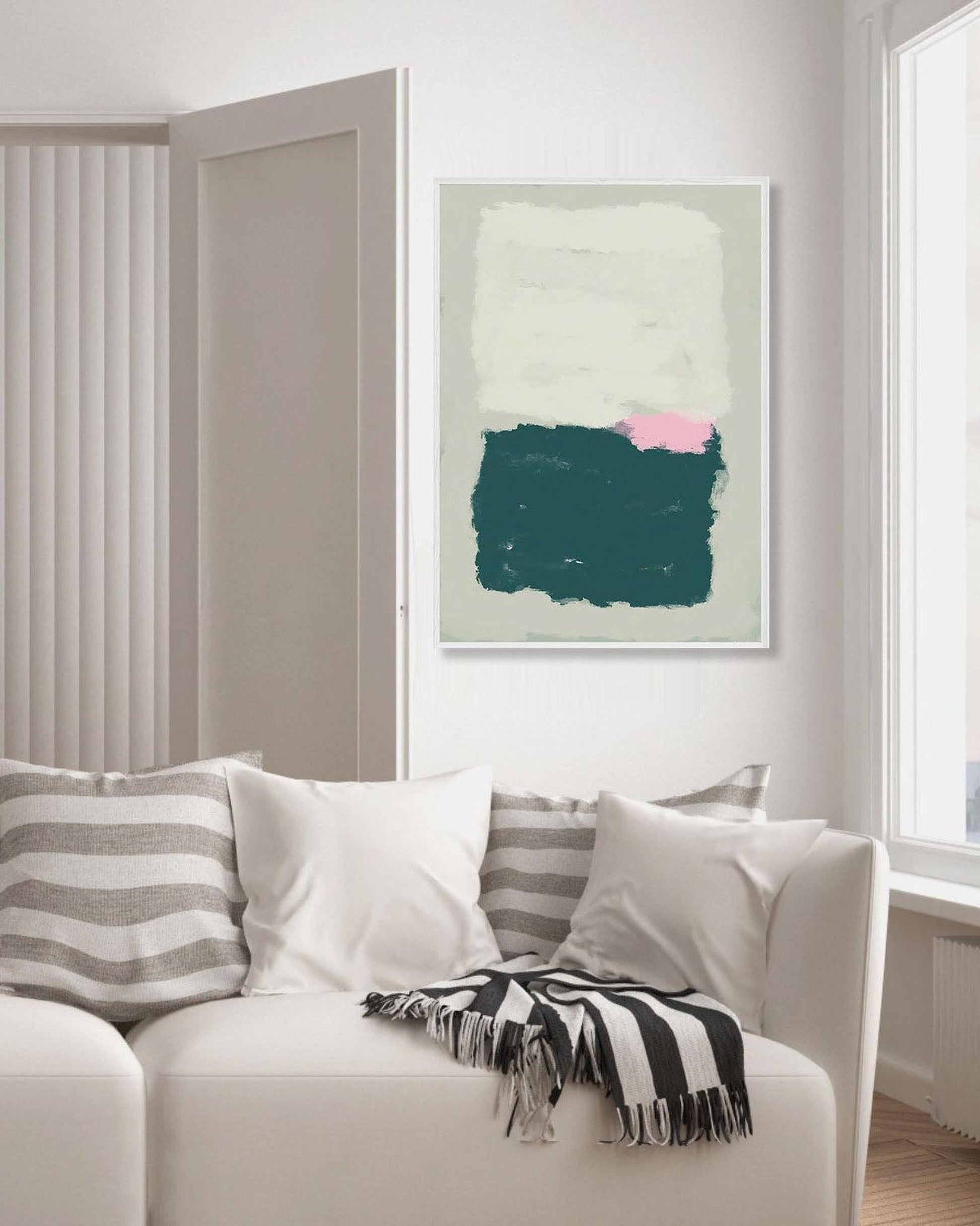 Modern living room with a white sofa, striped cushions, and a colorful abstract painting on the wall.