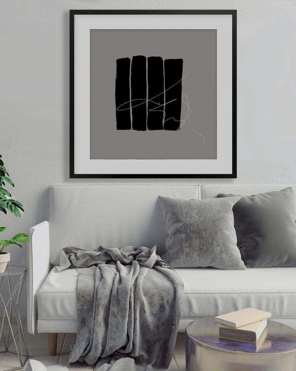 Living room with a gray sofa, abstract art on the wall, and decorative plants.