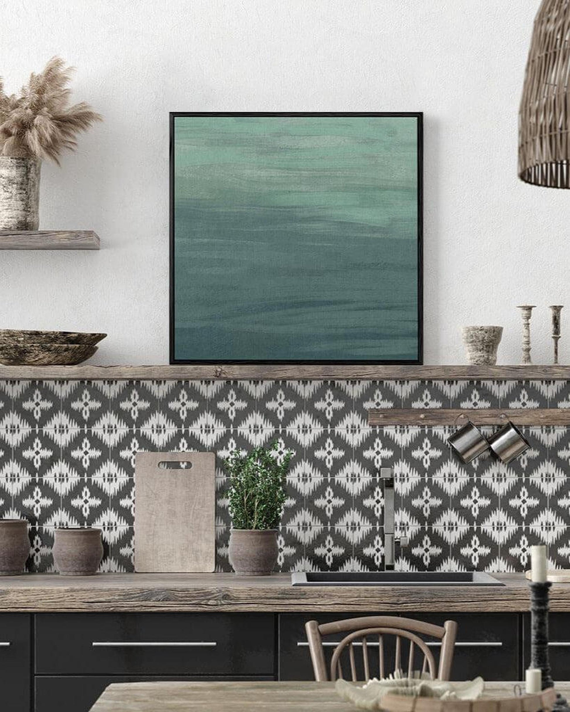 Kitchen with patterned backsplash, framed artwork, and decorative items.