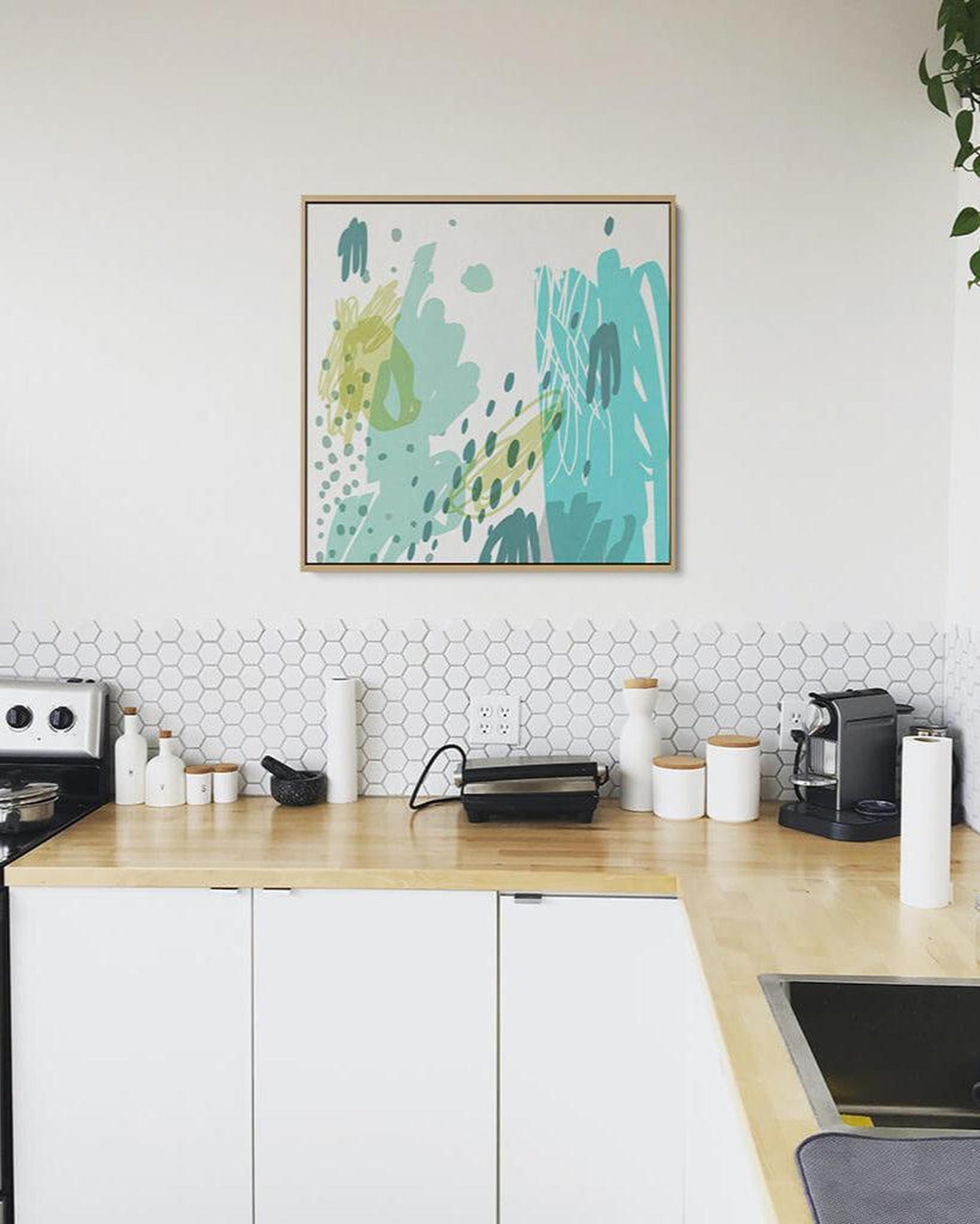 Modern kitchen with abstract art on the wall