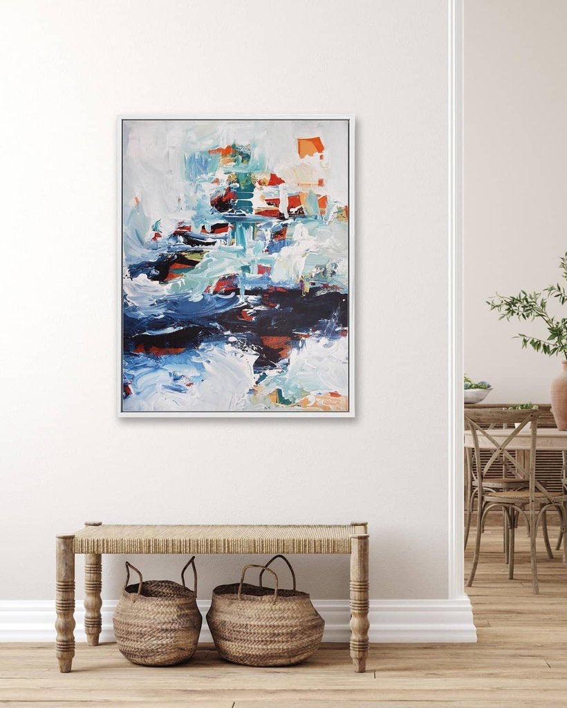 Abstract painting in a modern interior setting with a wooden bench and woven baskets.