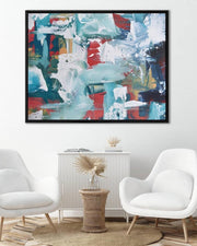 Abstract painting in a modern living room with white chairs and a side table.