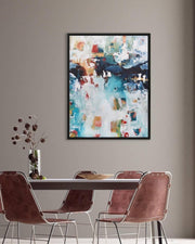 Abstract painting on a wall above a dining table with chairs