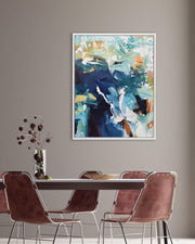 Abstract painting on a wall above a dining table with chairs