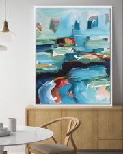 Abstract painting in a modern living room with a round table and chairs.