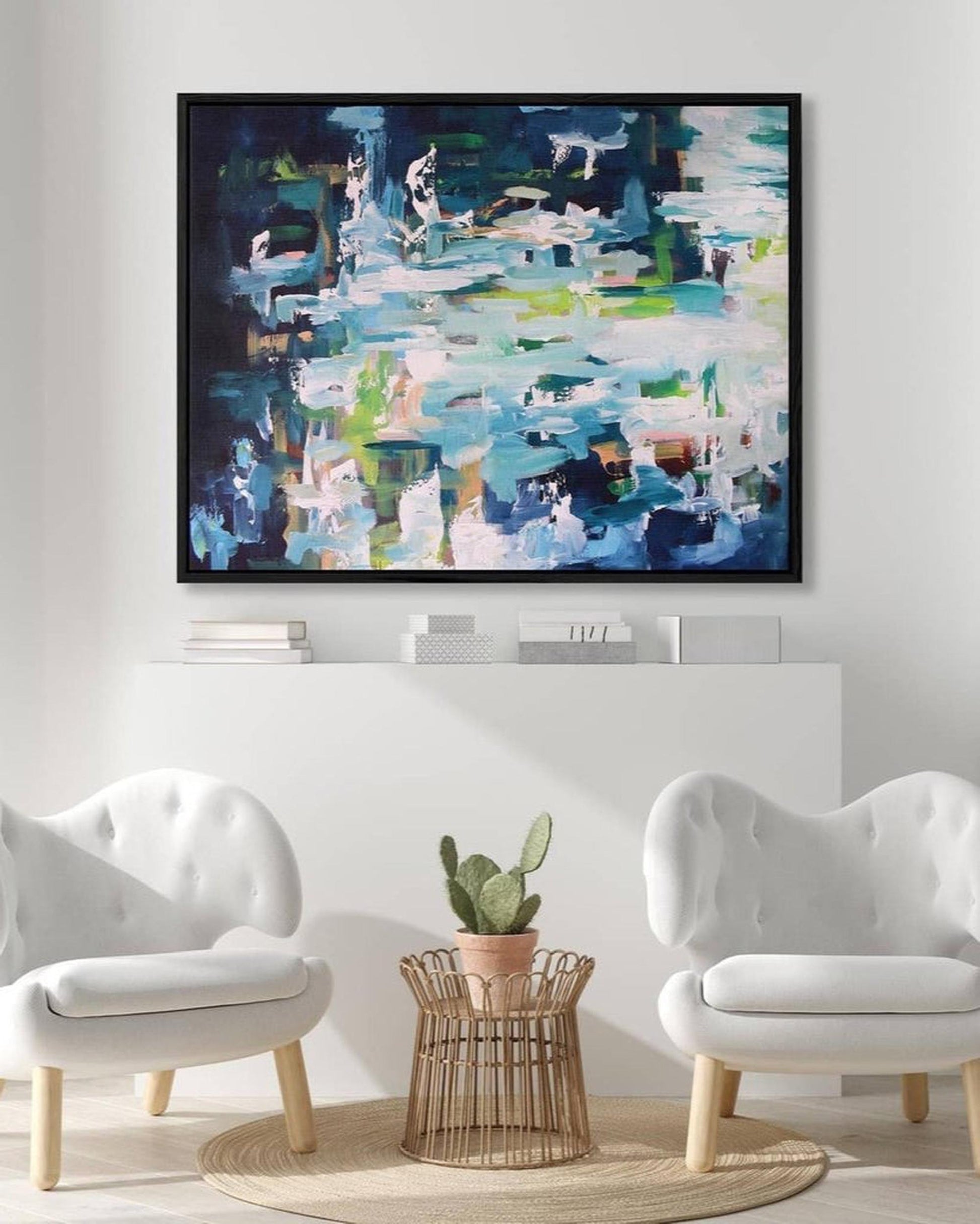 Abstract painting in a modern living room with white walls and furniture.