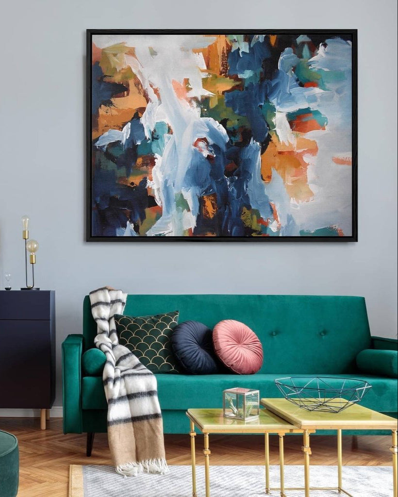 Living room with a teal sofa, colorful abstract painting, and decorative pillows.
