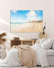TV mounted on a wall above a bed with a beach scene displayed