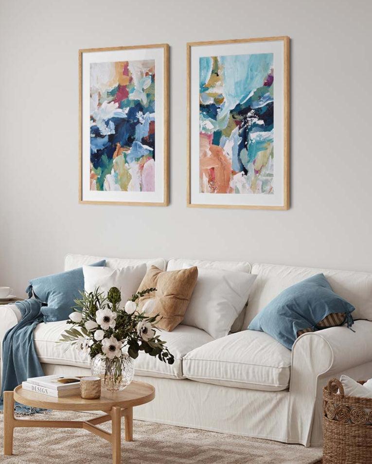 set of two abstract prints on a wall above a white sofa
