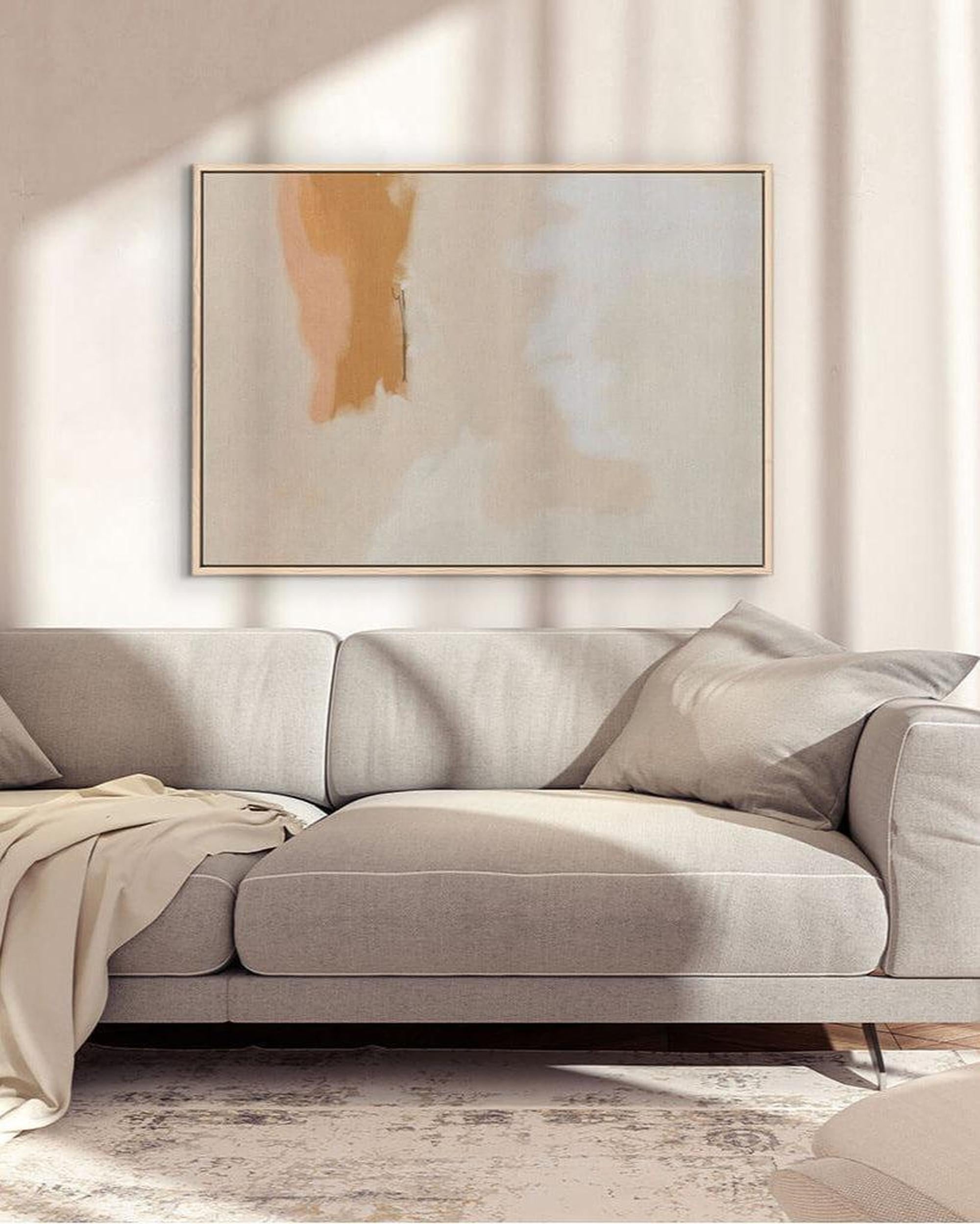 Gray sofa in a living room with abstract art on the wall