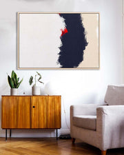 Modern living room with abstract art, wooden cabinet, and gray sofa.