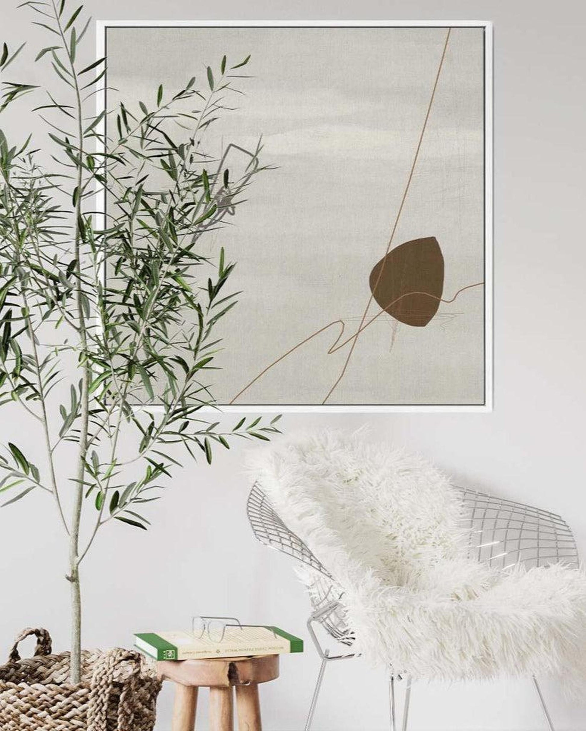 Decorative interior with abstract art, plant, and modern chair.