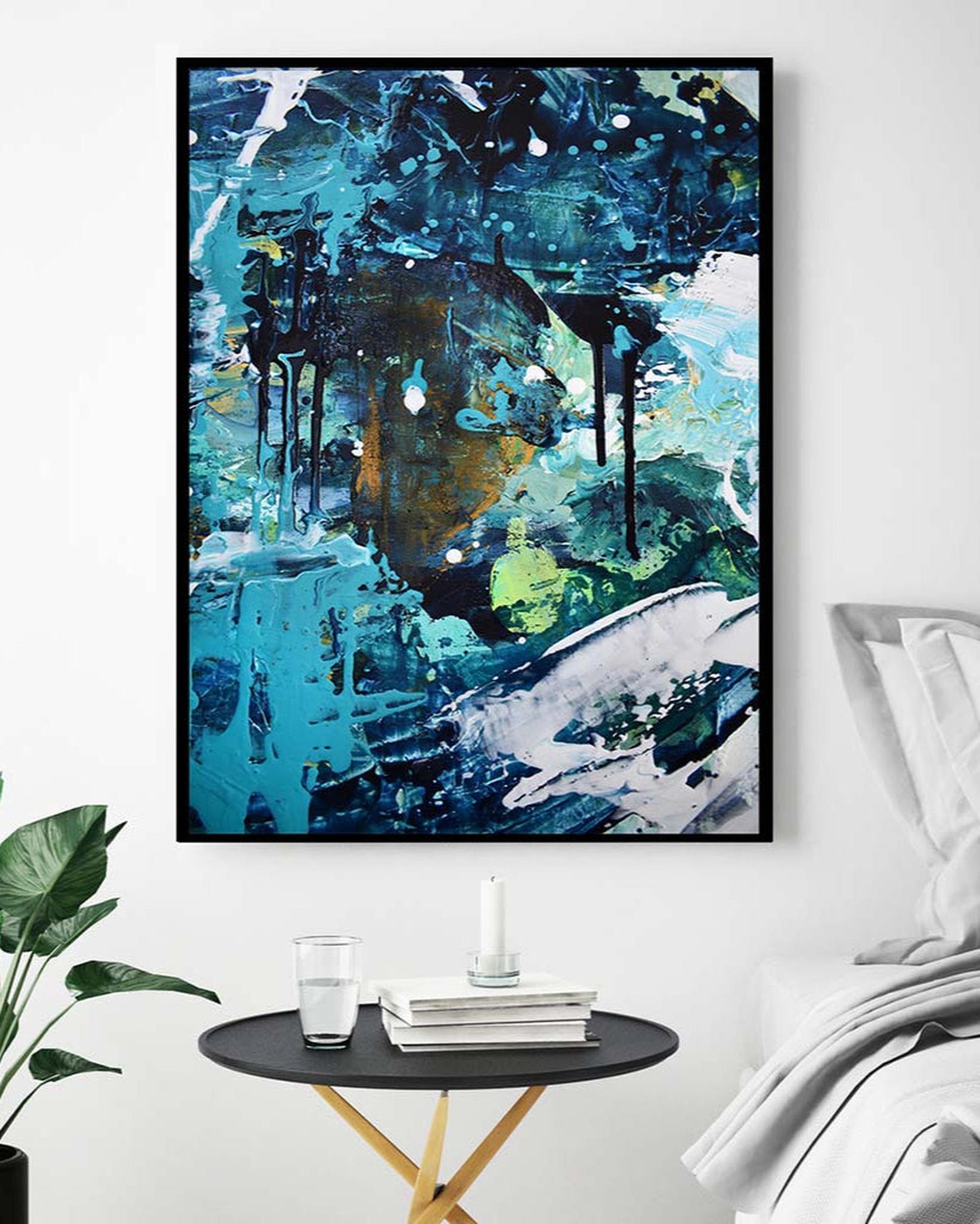 Abstract painting in a modern living room setting with a side table and plant.