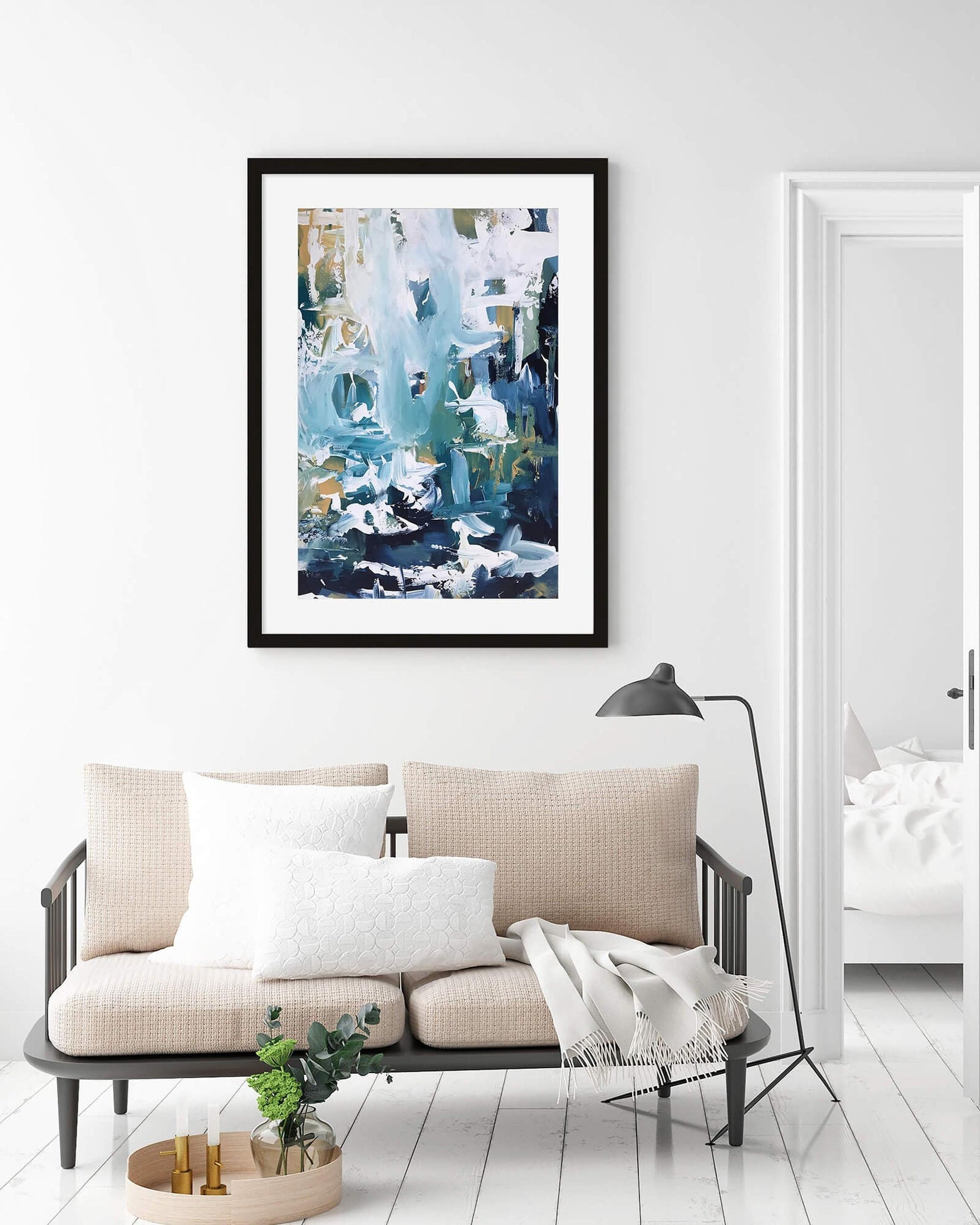 a framed print on a wall above a sofa in a living room